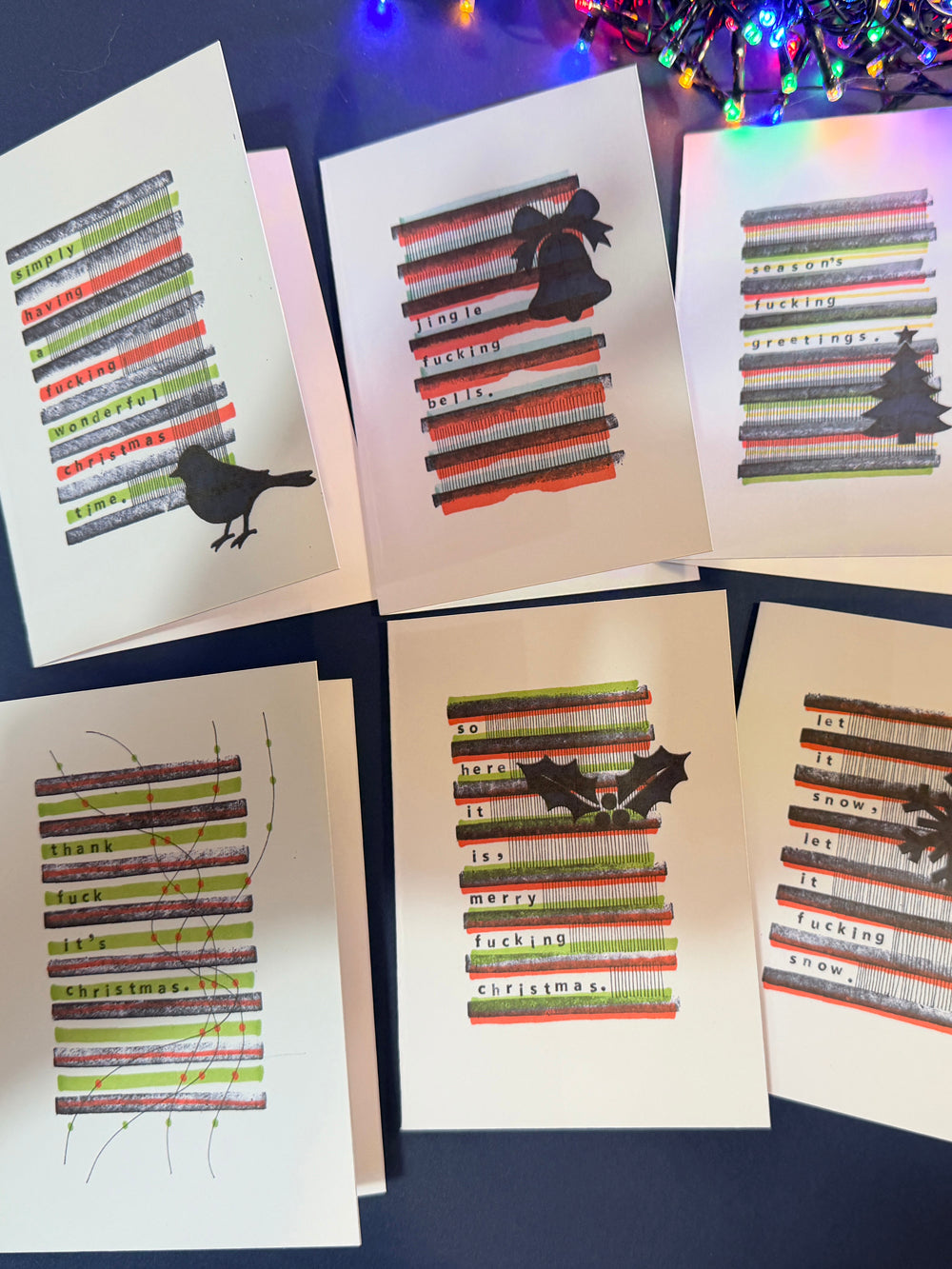 Pack of 6 sweary Christmas cards fanned out with envelopes